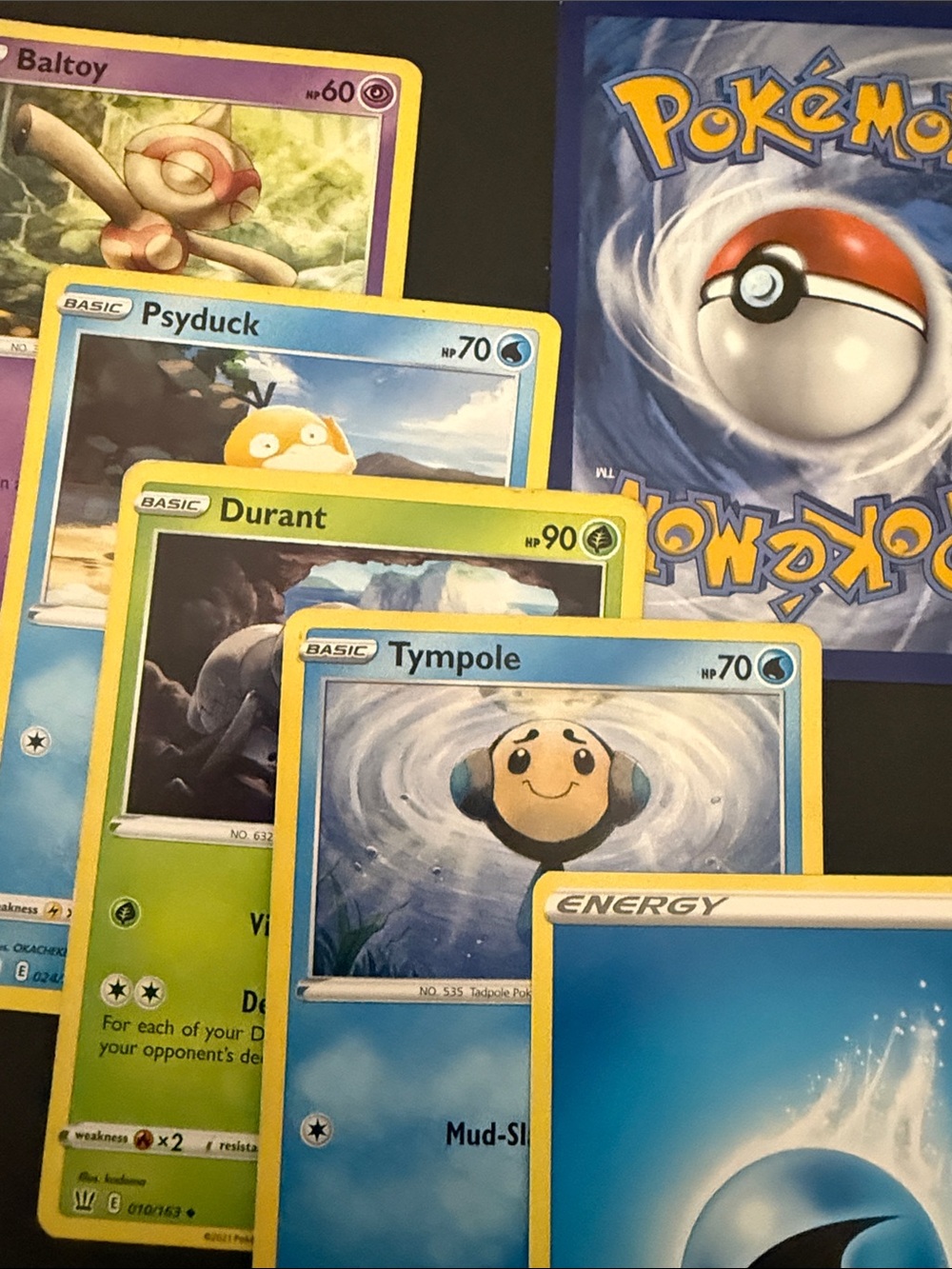 5 Pokémon cards with one mystery card
